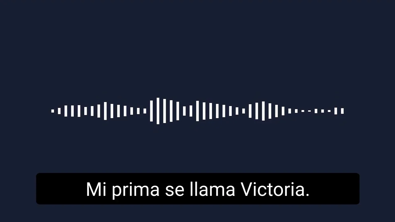 Centered white audio waveform above a black subtitle bar reading 'Mi prima se llama Victoria.' on a dark background.